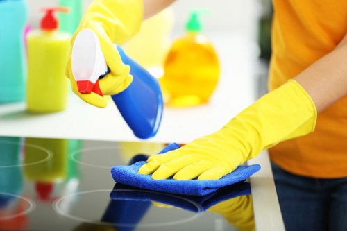 Cleaner placing a warning sign near a wet floor during routine work