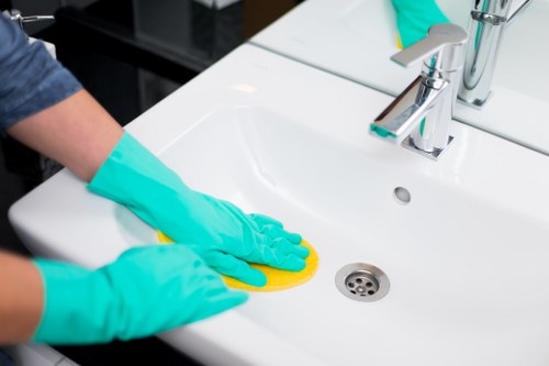 Team member handling cleaning products with appropriate safety precautions